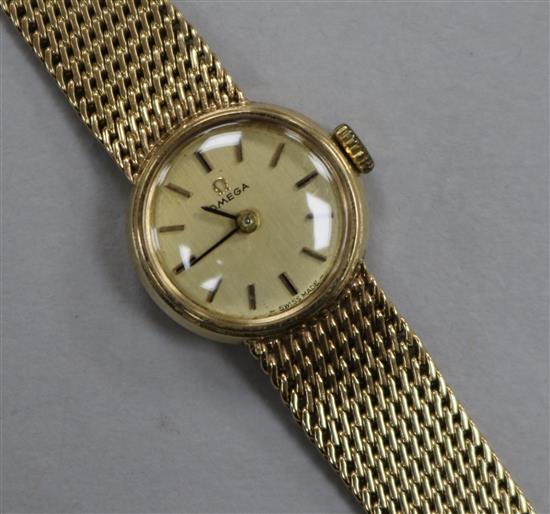 A ladys 9ct Omega manual wind wrist watch on integral Omega 9ct gold bracelet.